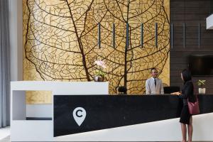 a man and a woman standing at a reception desk at The Capital Trilogy Menlyn Maine in Pretoria +140 photos