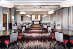 a conference room with tables and chairs and a projection screen at The Gant in Aspen +49 photos