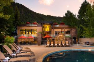 a house with a swimming pool and a resort at The Gant in Aspen