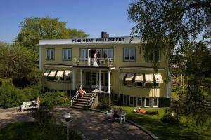 a man standing on the balcony of a house at Pensionat Frillesberg in Frillesås