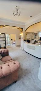 a large living room with a couch and a counter at Bay Court in Llandudno