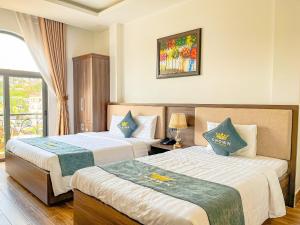Voodi või voodid majutusasutuse Crown Dalat Hotel toas
