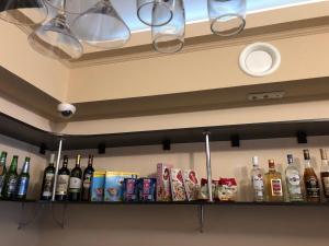 a shelf with bottles of alcohol on it at Lotus Hotel & Spa in Saratov