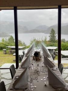 a long table with chairs and wine glasses at Hikers Camp, Part of Preikestolen BaseCamp in Jørpeland