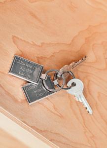 a metal key attached to a wooden door at Ring Stop Holiday Apartment in Sigulda