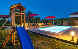 una piscina con tobogán y un parque infantil con sombrillas en Lovely Home In Kraj With Wifi, en Kraj