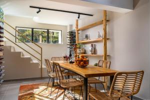 a dining room with a wooden table and chairs at Kipos Hotel in Rethymno