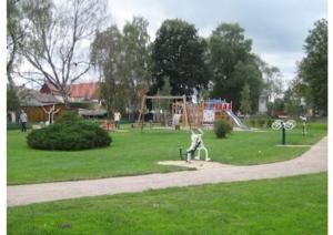 a park with a playground with a monkey statue at Urlaub am Peenestrom in Neukalen