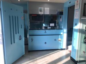 a room with two blue doors in a building at Hotel Doria in Chiavari