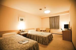 Postel nebo postele na pokoji v ubytování Narita U-City Hotel