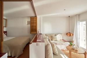A bed or beds in a room at Beachfront SUITE in CADAQUES center