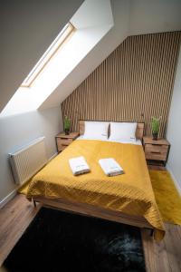 a bedroom with a bed with two towels on it at Apartament w Cieplicach 6 Gold in Jelenia Góra