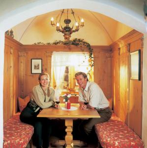 a man and a woman sitting at a table at Hotel Garni Serfauserhof in Serfaus