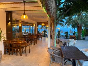 a restaurant with tables and chairs and a view of the ocean at Zest Exclusive Hotel & Spa in Ortakent