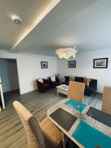 a living room with a table and a couch at Runnacleave Court in Ilfracombe
