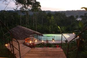 a resort with a pool and stairs and lights at Hamadryade Lodge in Puerto Misahuallí