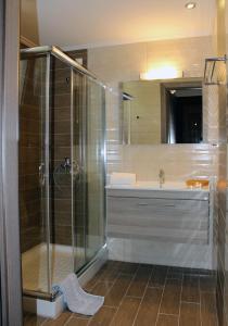 a bathroom with a shower and a sink at Imerti Resort Hotel in Skala Kallonis