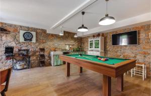 a pool table in a room with stone walls at 3 Bedroom Lovely Home In Hreljin in Hreljin