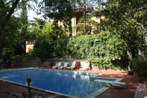 a swimming pool with lounge chairs and a building at Villa La Nussa in Capolona