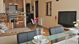 a living room with a table and a television at Garden House in Budapest