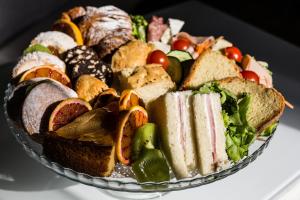 a plate of sandwiches and other foods on a table at B&B Palazzo Cerami in Catania