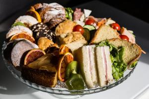 a plate of sandwiches and vegetables on a table at B&B Palazzo Cerami in Catania