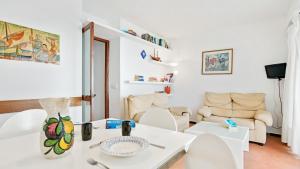 a white living room with a white table and chairs at Apartment Bone 2 - Llafranc in Llafranc