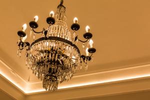 a large chandelier hanging from a ceiling at B&B Palazzo Cerami in Catania