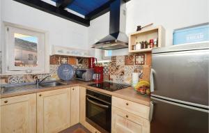 a kitchen with wooden cabinets and a stainless steel refrigerator at Lovely Home In Zedno With Wifi in Trogir