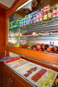 a refrigerator filled with lots of different types of food at Hotel Noguera El Albir in Albir