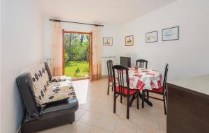 a kitchen and dining room with a table and chairs at Gorgeous Apartment In Labin With Wifi in Labin