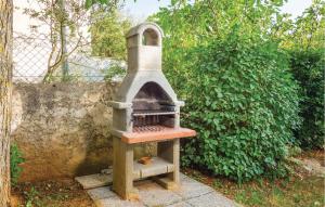 a stone oven sitting next to a wall at Apartment Labin Presika Ii in Labin