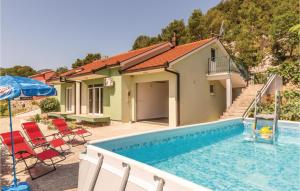 a villa with a swimming pool and a house at Cozy Home In Stasevica With Wifi in Staševica