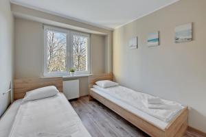 Posteľ alebo postele v izbe v ubytovaní Comfort Apartments Gdynia Centrum