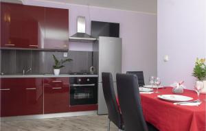 a kitchen with a table with a red table cloth at 2 Bedroom Stunning Apartment In Trstenik in Trstenik