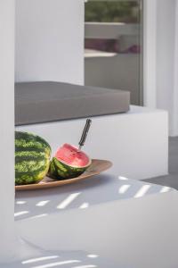a plate with a watermelon on a table at Kostantis Town Suites in Mikonos