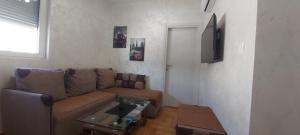 a living room with a couch and a table at Apartment Boki in Budva