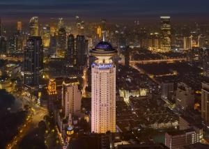 a tall building with a blue dome on top at night at Radisson Blu Hotel Shanghai New World in Shanghai
