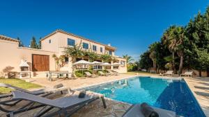 a villa with a swimming pool and a house at Villa Etruria close to Playa d'en Bossa in Sant Josep de sa Talaia