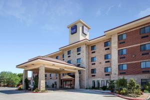 a hotel with a clock tower on top of it at Sleep Inn & Suites in Lubbock