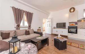 a living room with a couch and a kitchen at Awesome Apartment In Biograd With Kitchen in Biograd na Moru