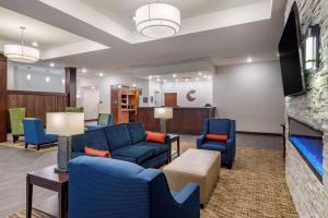 a living room with blue couches and chairs at Comfort Suites in Newnan