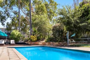 a swimming pool in a yard with trees at Quality Inn Dubbo International in Dubbo