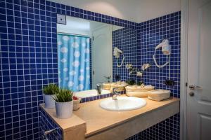 Baño de azulejos azules con lavabo y espejo en Mirador del Mar Villas, en Puerto Rico de Gran Canaria