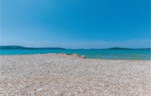 a rocky beach with the ocean in the background at Two-Bedroom Apartment In Jadrija in Jadrija