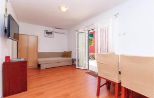 a living room with a couch and a table at Two-Bedroom Apartment In Jadrija in Jadrija +15 photos