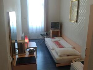 a room with a bed and a television in it at Scotty's Boutique Hotel in Sofia +51 photos