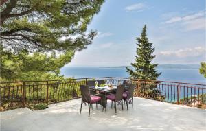 a table and chairs on a patio overlooking the ocean at Awesome Home In Brela With Jacuzzi in Brela