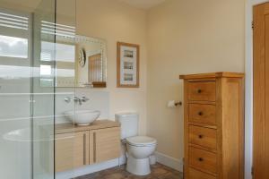 a bathroom with a toilet and a sink and a shower at Hazelmere House in Woolacombe