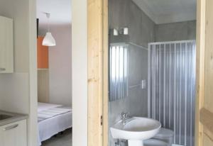 a bathroom with a sink and a toilet and a shower at Villa Cisterna - Direzione Salento in San Foca